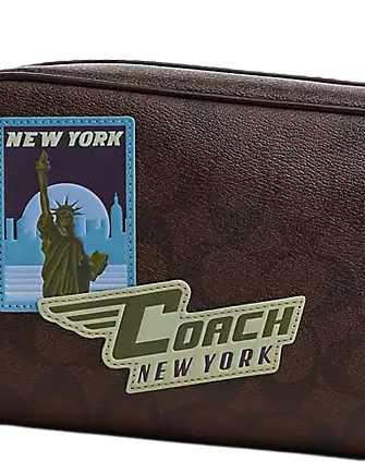 Trekker bag in signature canvas with travel patches hotsell