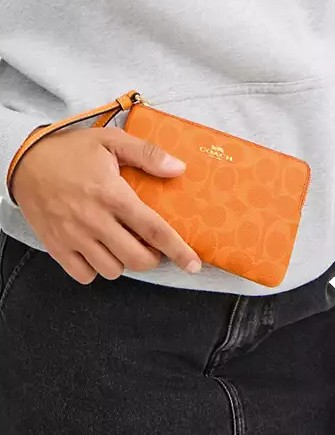 Coach Corner Zip Wristlet In Signature Canvas Bright Mandarin