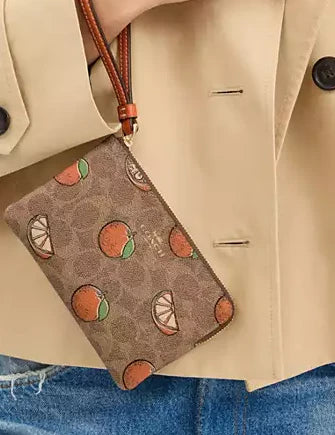 Coach Corner Zip Wristlet In Signature Canvas With Orange Print Tan