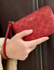 Coach Corner Zip Wristlet In Signature Canvas Bold Red