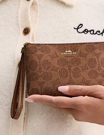 Coach Corner Zip Wristlet In Signature Canvas Brown Copper