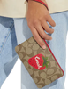 Coach Corner Zip Wristlet In Signature Canvas With Wild Strawberry